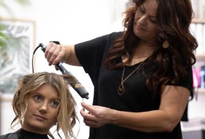 Hairdresser curling hair